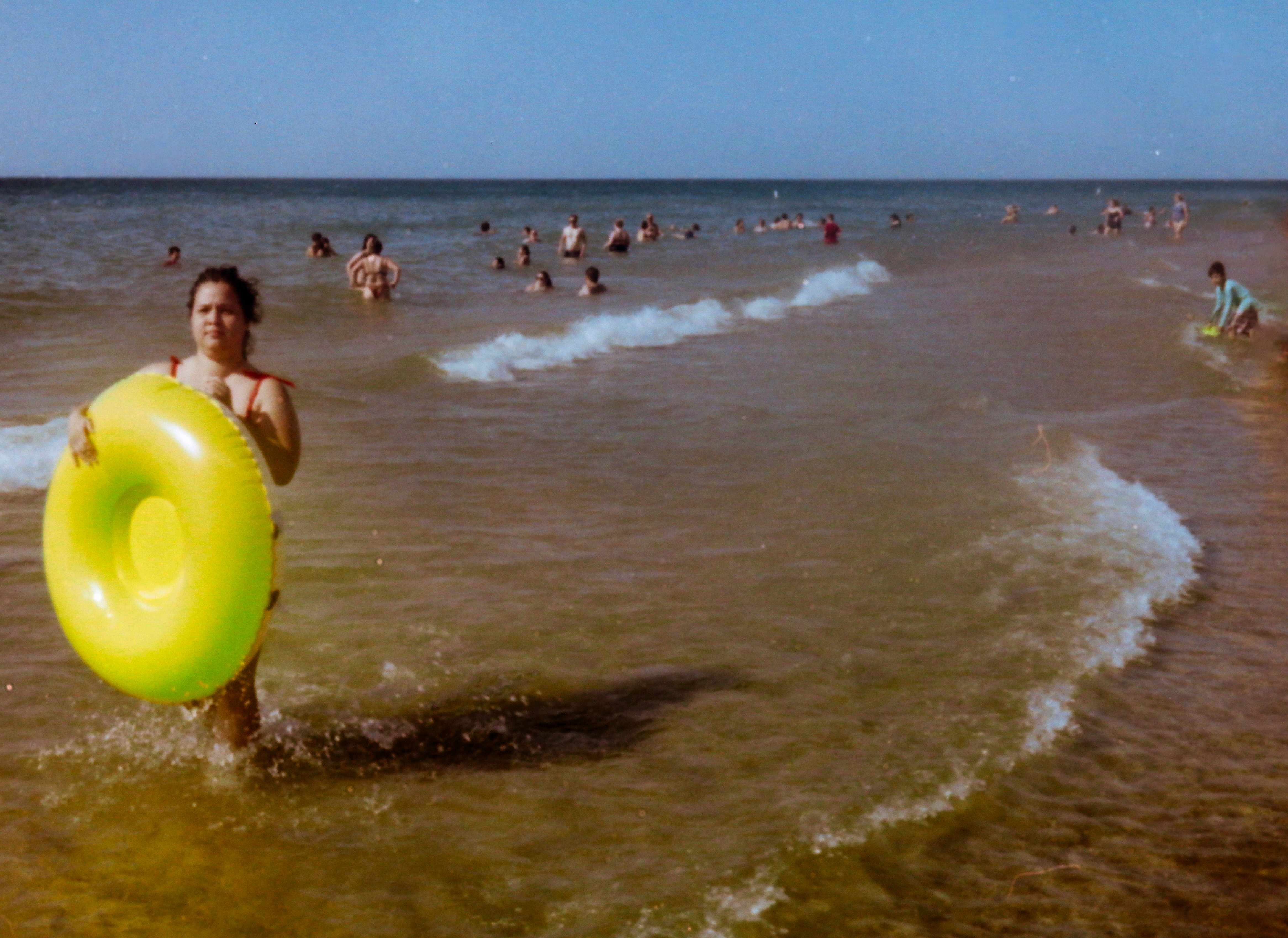 Person with yellow inflatable ring in water