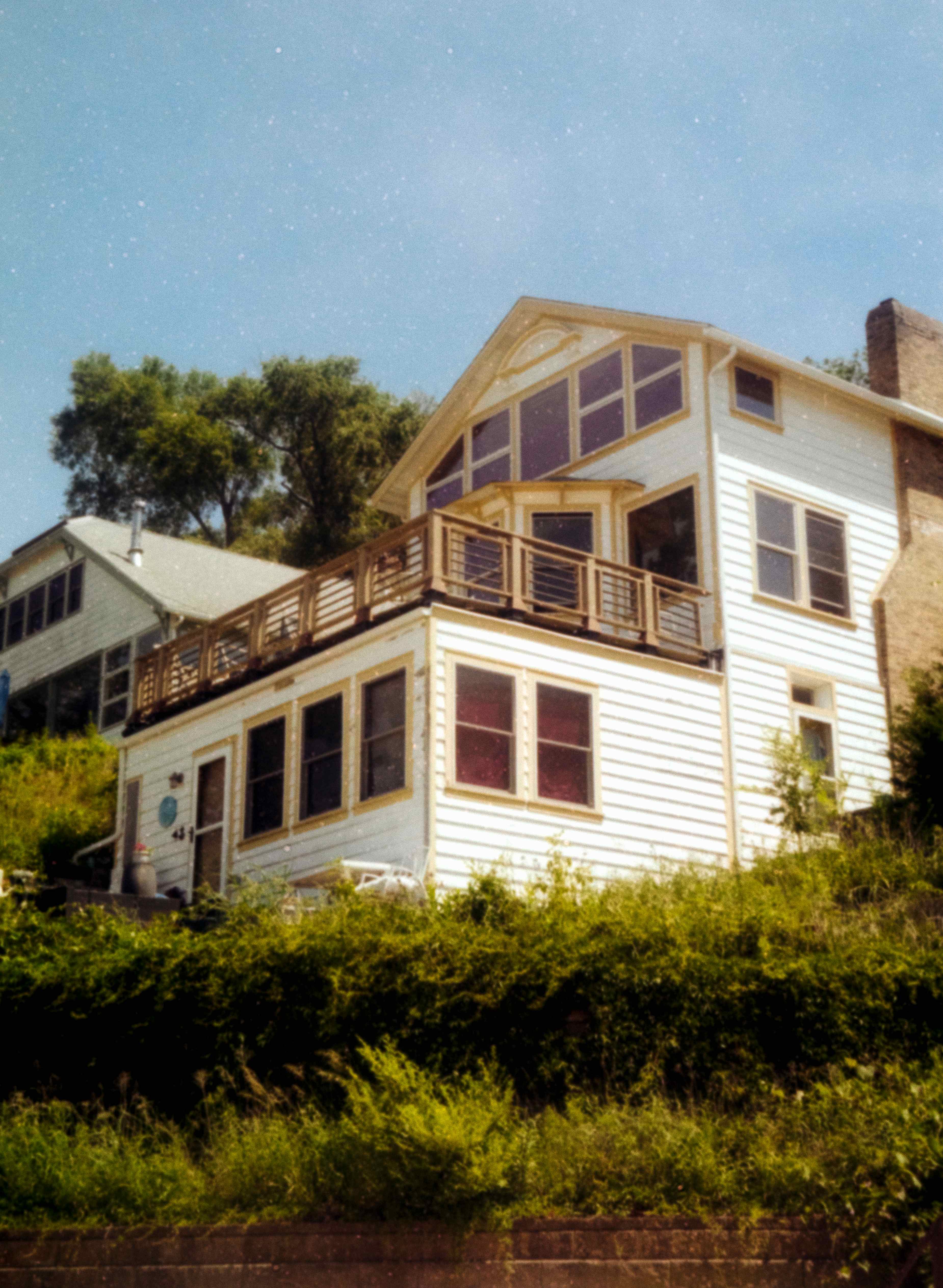 White beach house among greenery