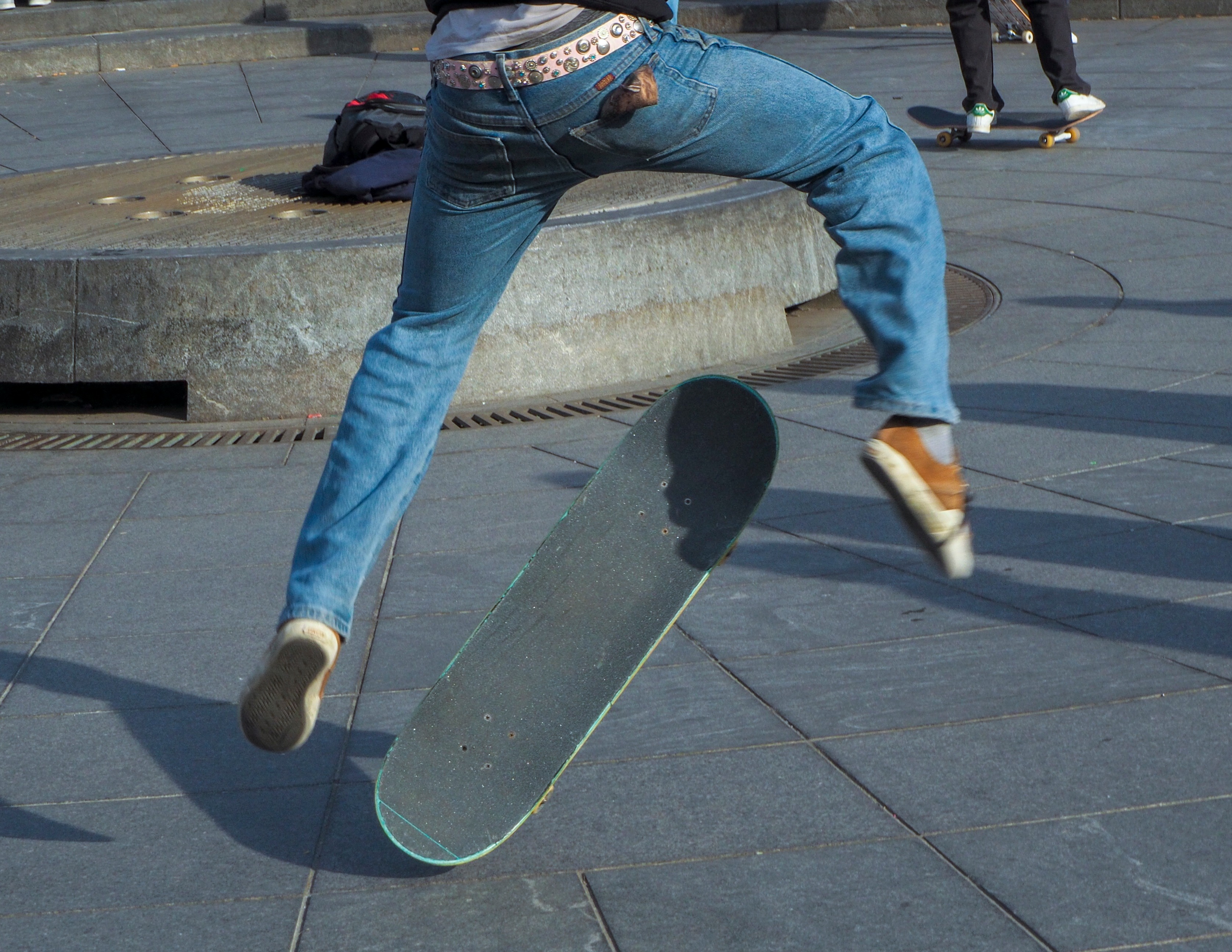 Close-up of skateboarder doing kickflip trick