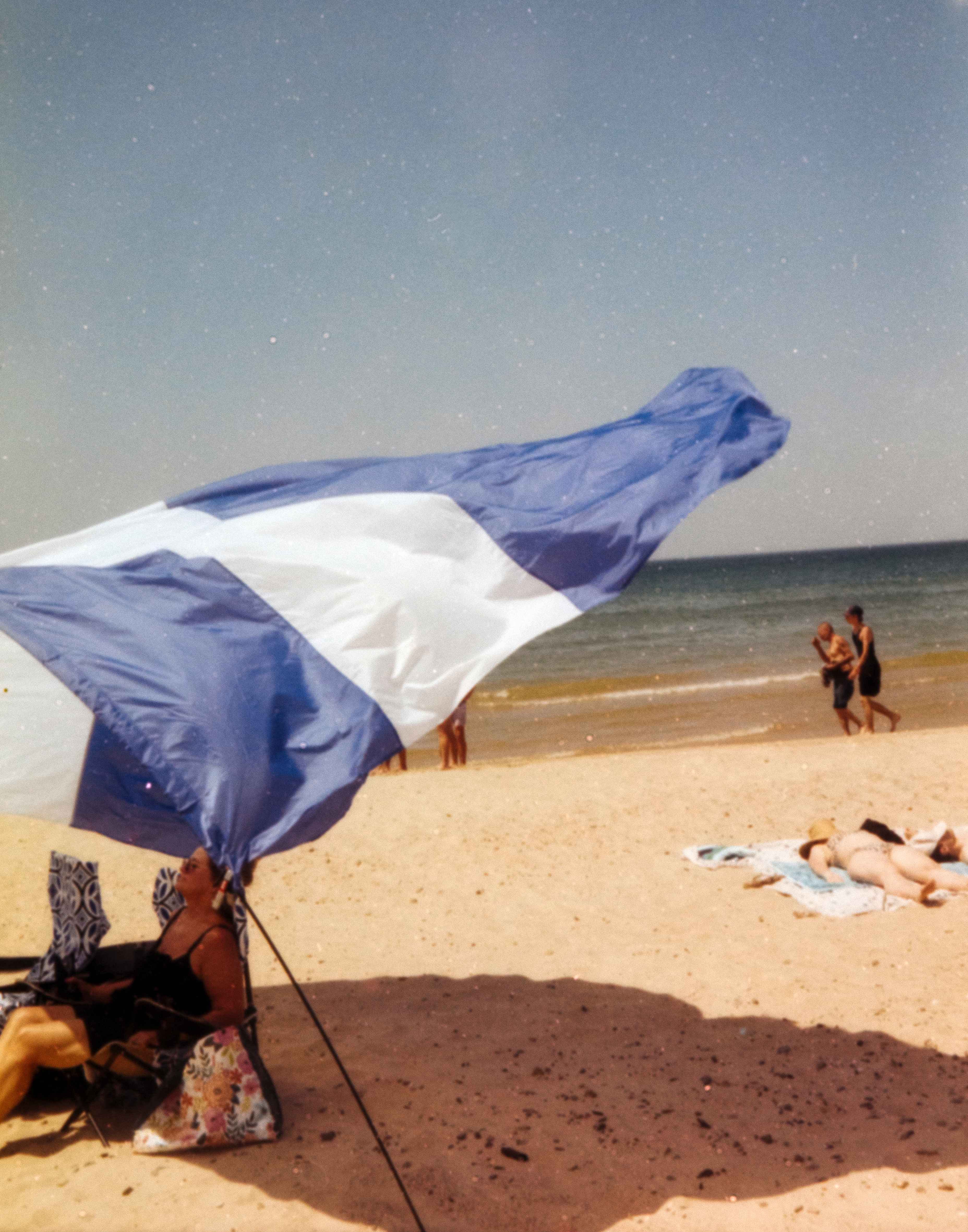Beach umbrella blowing in wind